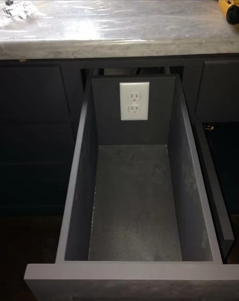 New GFCI-style outlet installed inside a cabinet for a built-in appliance