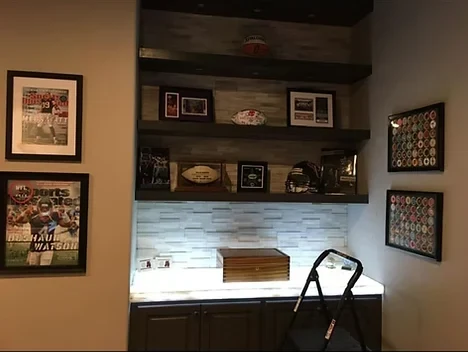 Home bar and den with reclaimed wood shelving and accent lighting installed