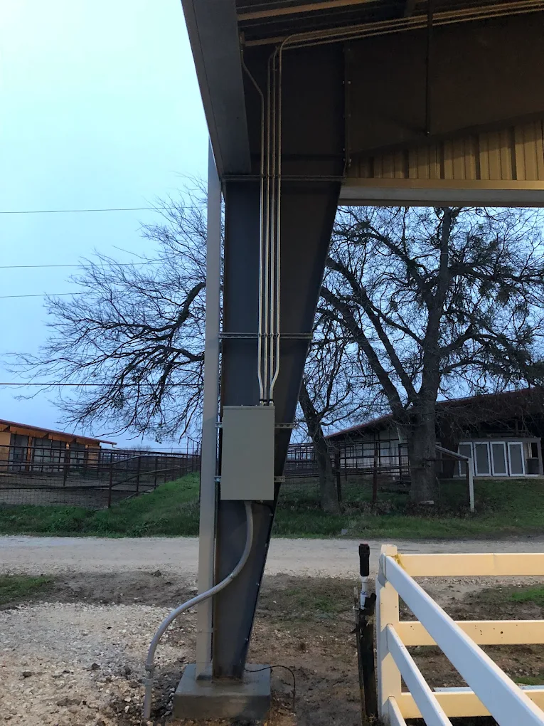 Exterior conduit run and disconnect box installed on a metal barn column outside Montgomery, TX